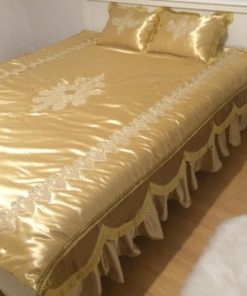 Bedspread of golden satin with lace details
